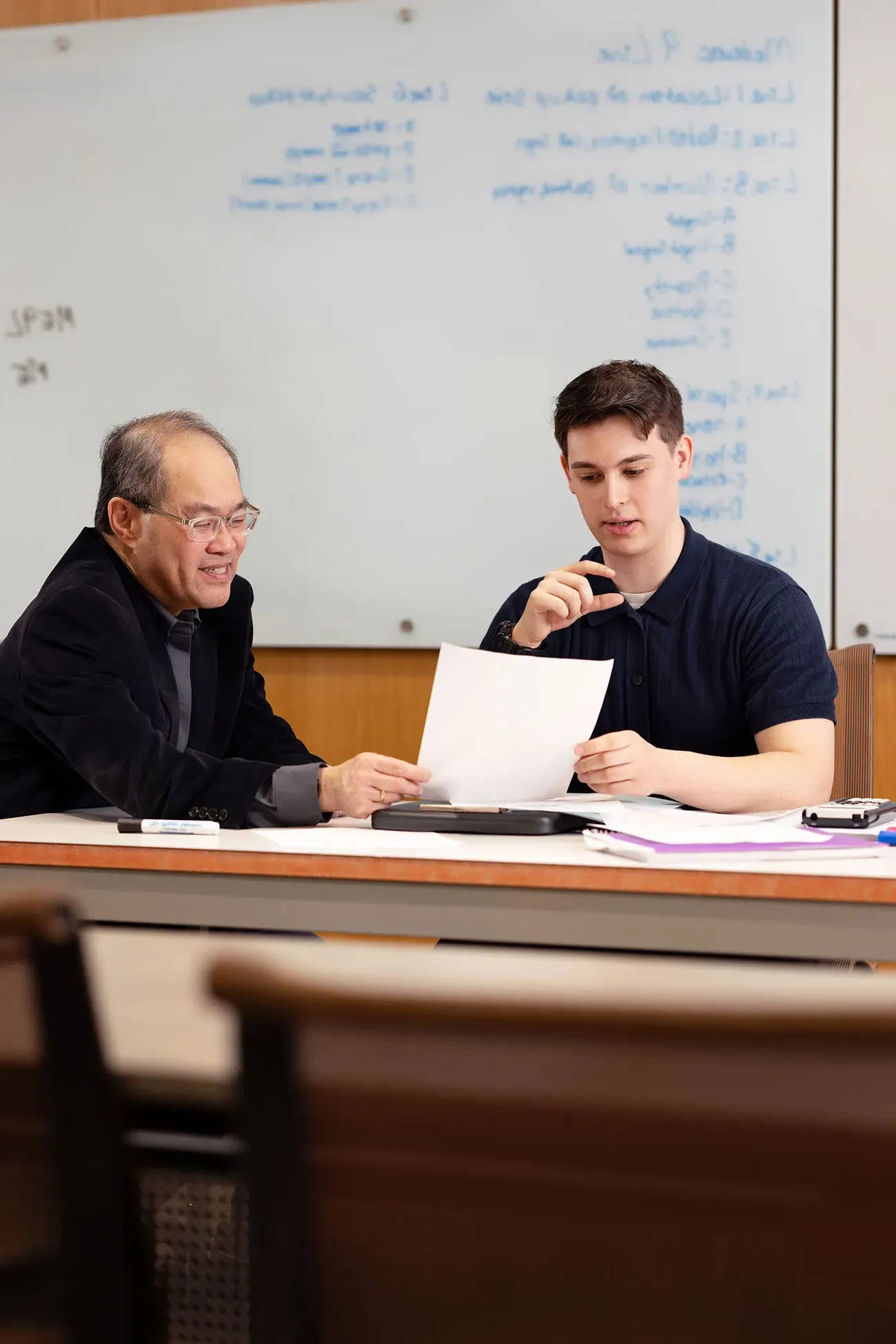 Student Benjamin Johnson working with a professor.